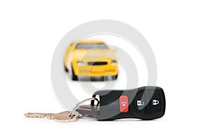 Car keys and car at background