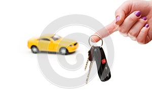 Car keys and car at background