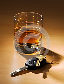 Car keys and glass with alcohol