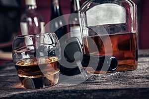 Car keys on glass with alcohol drink