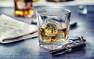 Car keys and glass of alcohol on table in pub or restaurant
