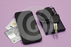 Car keys, mobile phone and credit cards on blue