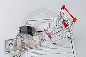 Car keys, money and shopping cart. Car sale or purchase concept