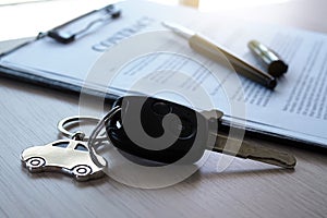 Car keys placed on contract documents about car loans