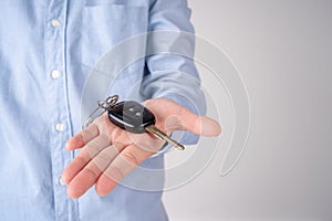 Car Keys. Seller hand giving keys isolated on a white background