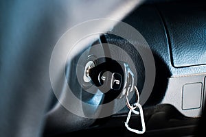 Car keys start the combustion of modern cars. Car key in keyhole