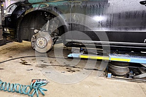 The car lifted by a pneumatic jack, wheel replacement