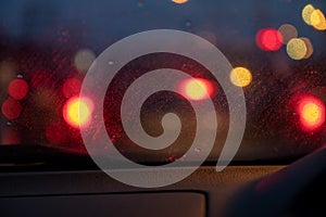 Car light at night while it`s raining