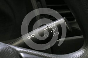 Car light switch control paddle on steering wheel