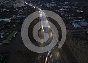The car light trails in the city street Traffic. Top Down Aerial Drone view of a road at night i