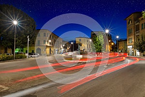 Car light trails on the crossroad during night in the city of Um