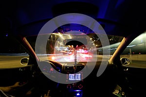 Car light trails, driver inside
