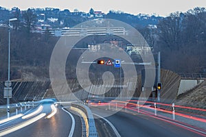 The car light trails in front of a tunnel at Lugano