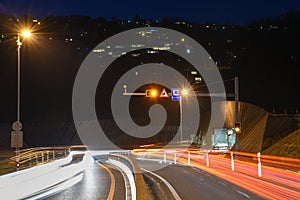 The car light trails in front of a tunnel at Lugano