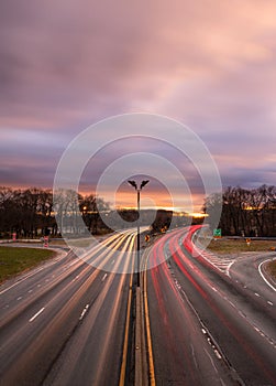 Car light trails on a highway during rush hour commute during sunset. Long Island NY