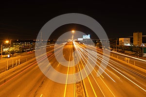 Car light trails on highway street or road in Bangkok, Thailand. Urban city at night in transportation, business, or technology