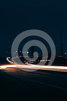 Car light trails on a road at night
