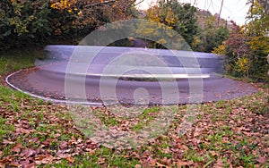 Car lights on a curve at night in the city