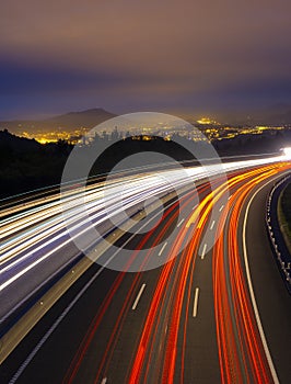 Car lights on the highway in the direction of the city