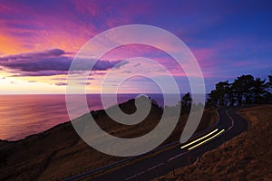 Car lights on the road of Mount Jaizkibel at sunset