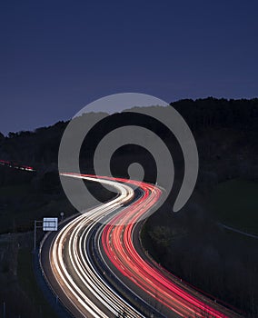 Car lights on the road at night heading to the city