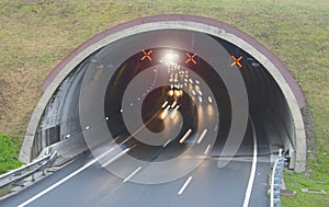 Car lights running in a road tunnel,