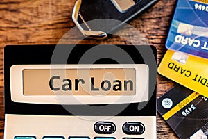 Car loan concept with text,calculator and credit card and car key ,calculating for debt payment background