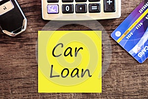 Car loan concept with text,calculator and credit card and car key ,calculating for debt payment background