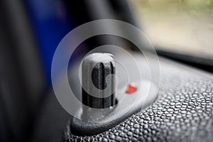 Car locking stick in older passenger car providing the lock of the vehicle as a symbol of security, safety, precaution and prot