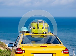 Car with luggage on the roof ready for summer vacation