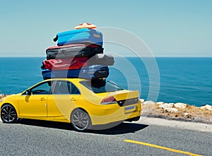 Car with luggage on the roof ready for summer vacation