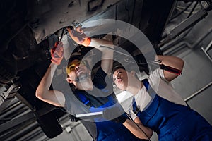 A car machinist inspect pendant with flashlight