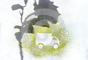 A car made of green powder and the shadow of plants on a light background. Online shopping. Flowers delivery concept