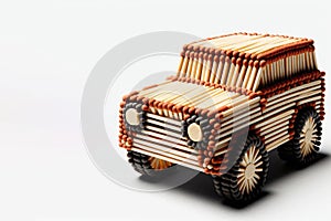 A car made of matches on a light background. Space for text.