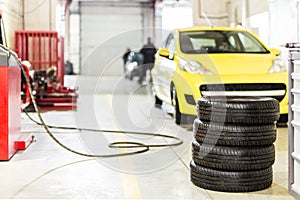 Car maintenance and service center. Vehicle tire repair and replacement equipment. Seasonal tire change