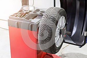 Car maintenance and service center. Vehicle tire repair and replacement equipment. Seasonal tire change