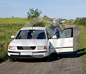 Car and man on country road