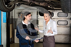 Car mechanic with angry female customer