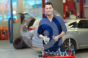 Car mechanic in auto repair shop