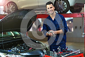 Car mechanic in auto repair shop