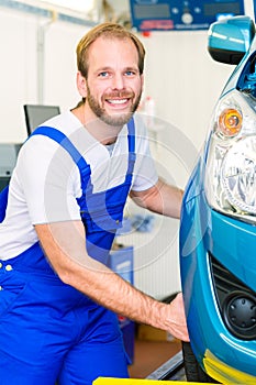 Car mechanic and auto in service workshop