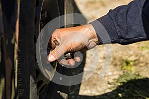 Car mechanic changing car wheel and tire by wrench at car garage in Bucharest, Romania, 2021