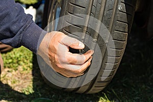 Car mechanic changing car wheel and tire by wrench at car garage in Bucharest, Romania, 2021