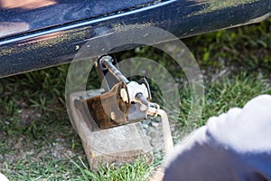 Car mechanic changing car wheel and tire by wrench at car garage in Bucharest, Romania, 2021