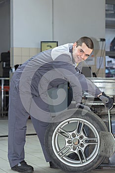 Car mechanic changing tire