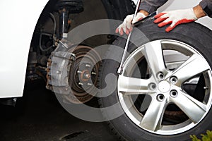 Car mechanic changing tire.