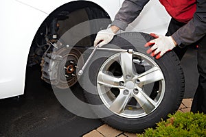 Car mechanic changing tire.