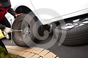 Car mechanic changing tire.