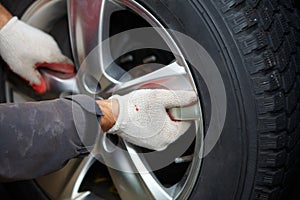Car mechanic changing tire.