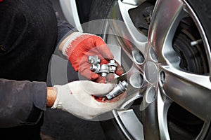 Car mechanic changing tire.